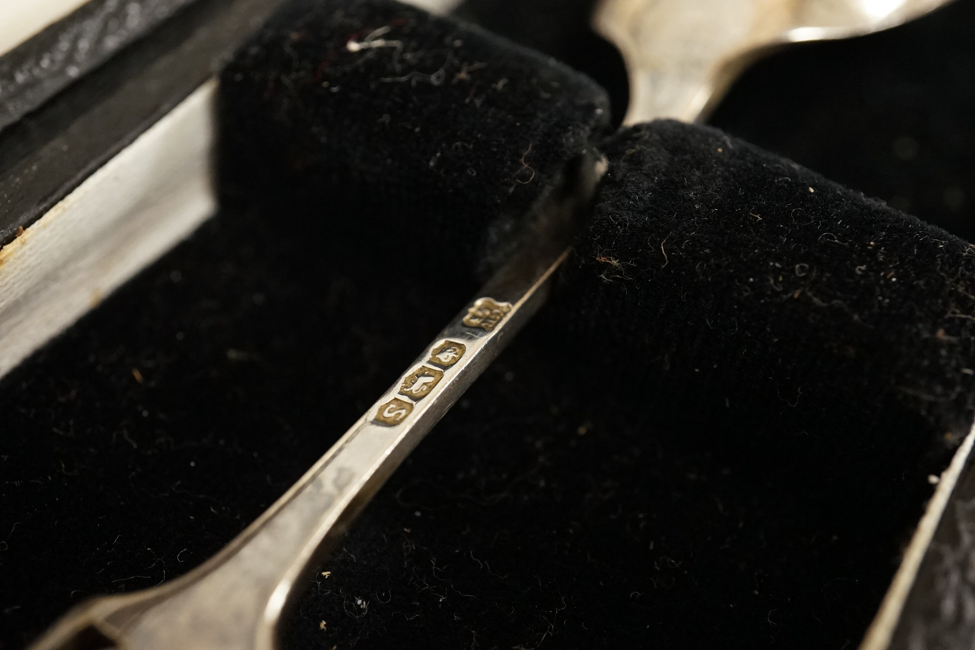 A cased pair of Victorian silver circular salts, by Edward Hutton, London, 1886, lacking spoons, together with a cased set of six silver bean end coffee spoons, a cased silver spoon, a small silver 'Dunlop Golf Ball Hole